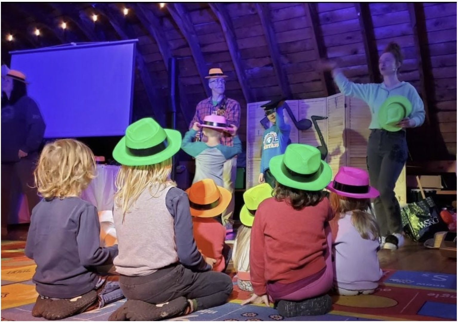 Children wearing bright neon hats during The Hat Song at a Johnny Only kids show